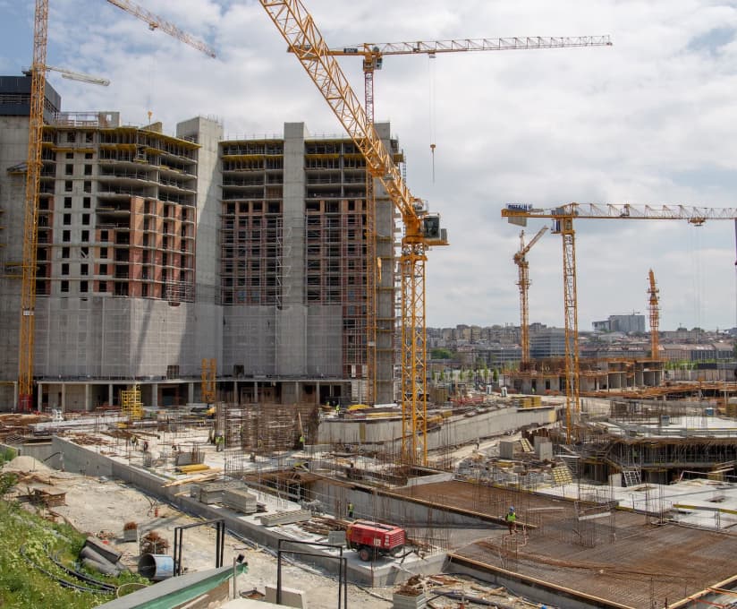 Construction site with excavation and concrete work in progress